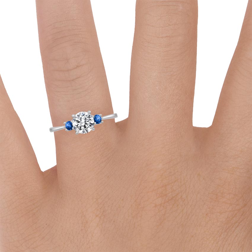 18K White Gold Selene Ring with Sapphire Accents, large zoomed in top view on a hand