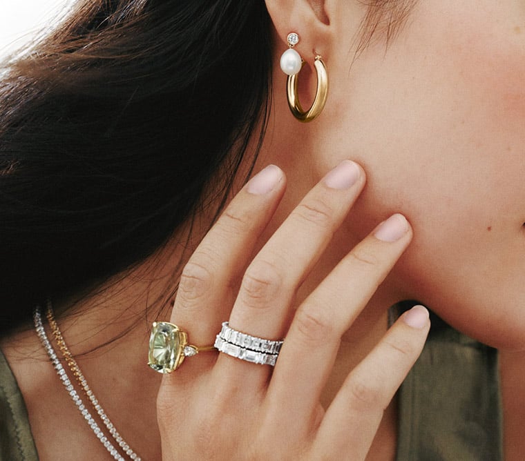 Model wearing an assortment of fine jewelry