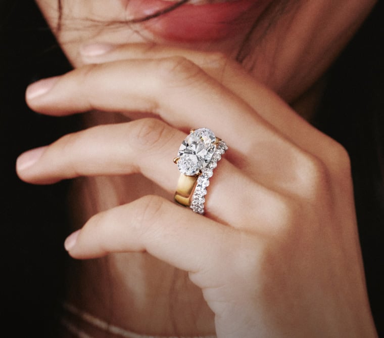 Model wearing a stack of diamond wedding rings