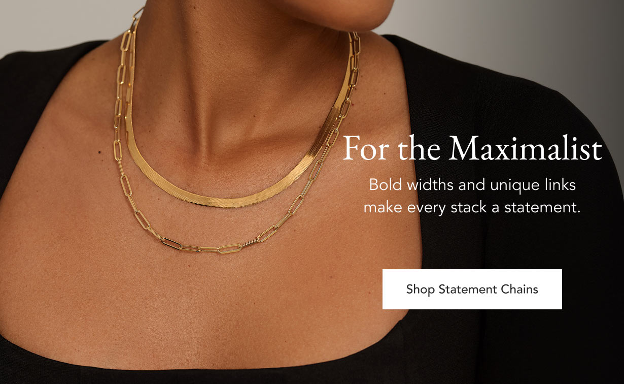 Model wearing bold, chunky chain necklaces.