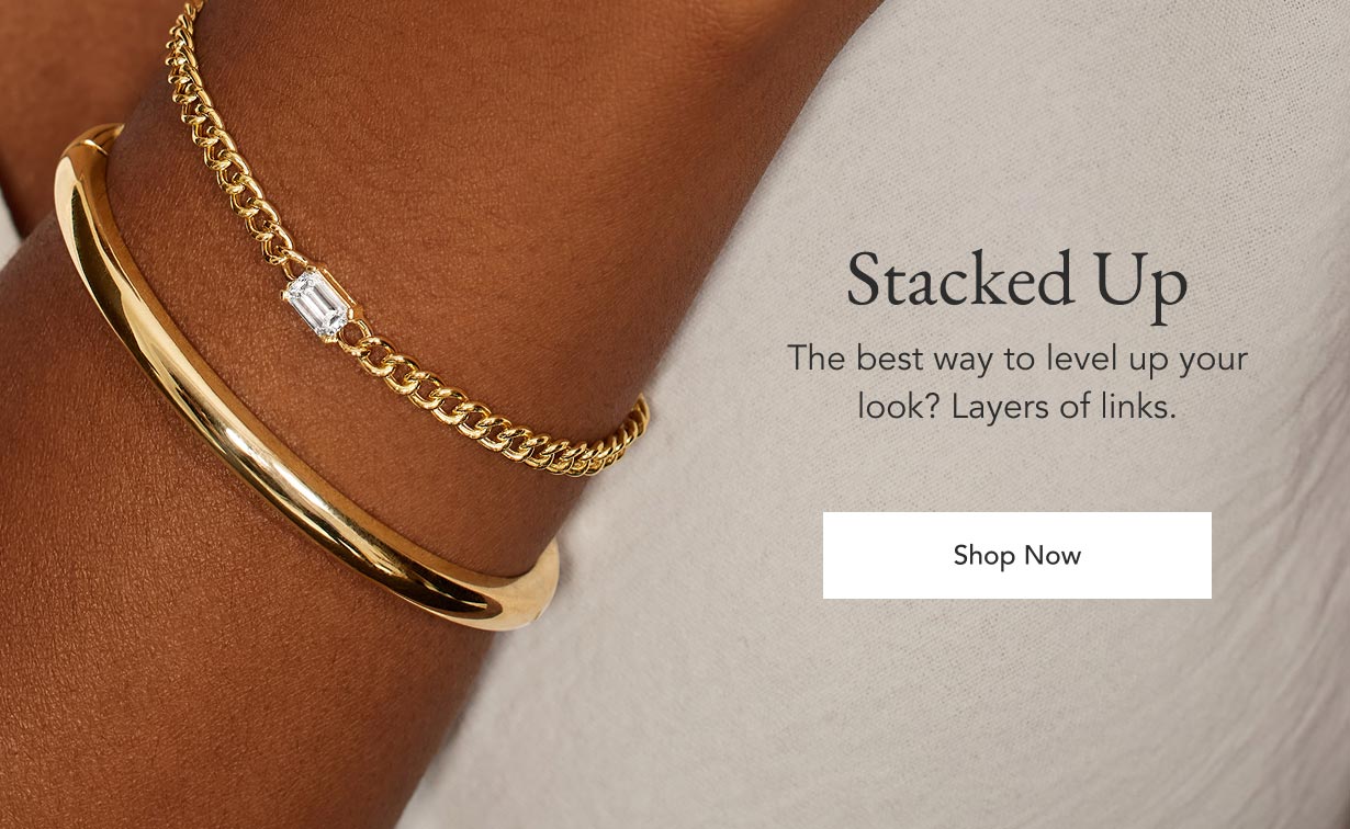 Model wearing stacked bracelet set.