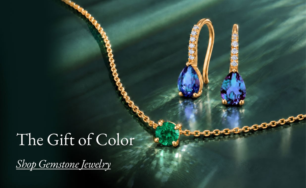 Sapphire drop earrings and an emerald solitaire necklace.
