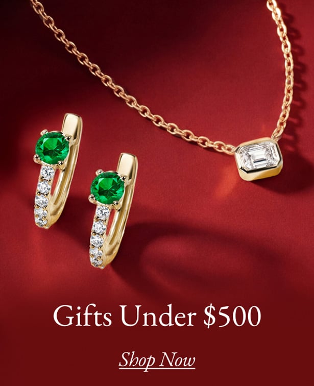 A pair of emerald and diamond hoop earrings and a diamond bezel pendant under $500.