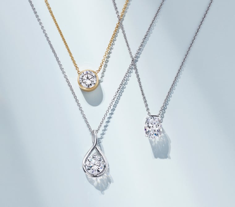 Assortment of diamond solitaire necklaces.