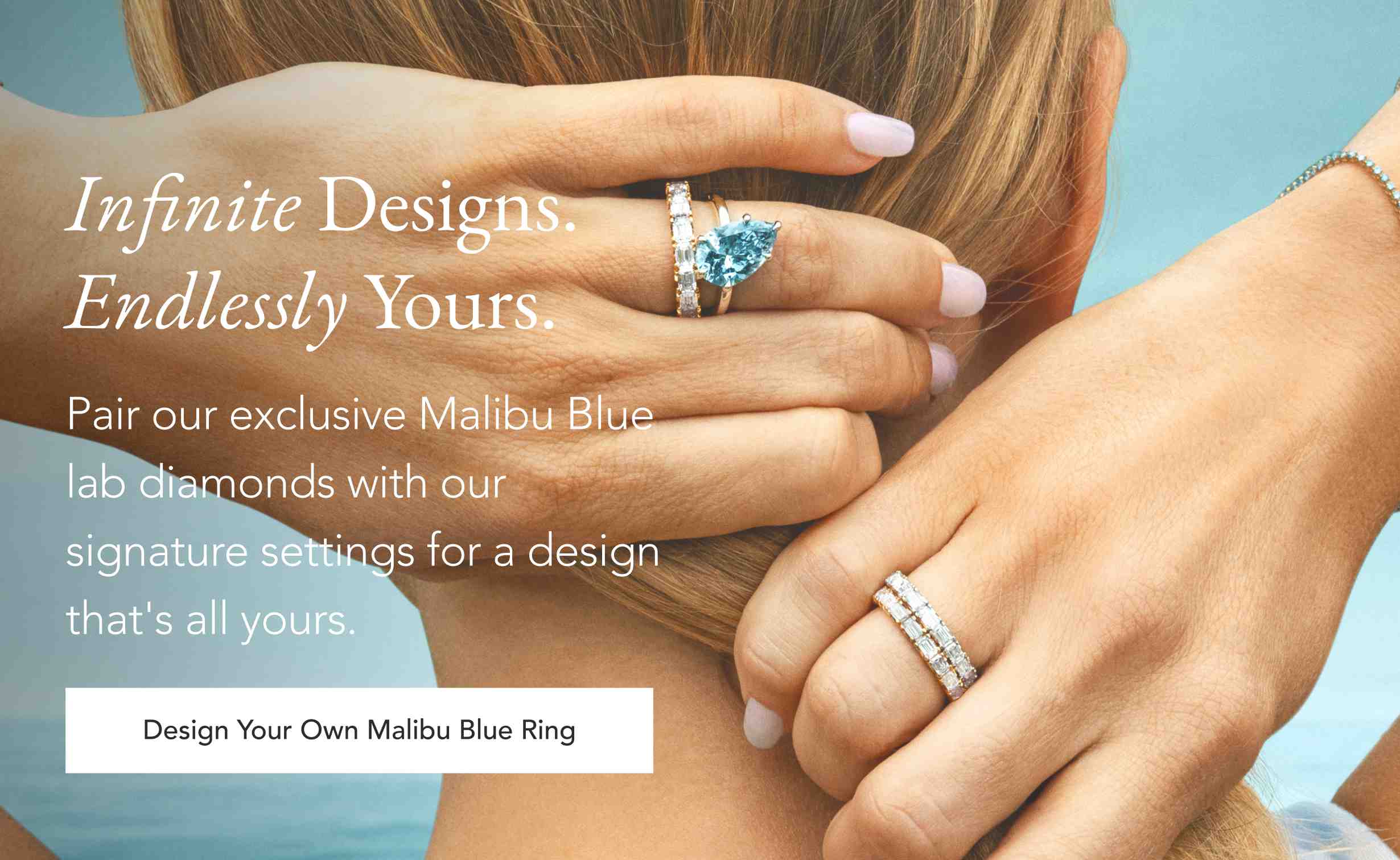 Person wearing a Malibu Blue lab diamond ring and a diamond wedding band.