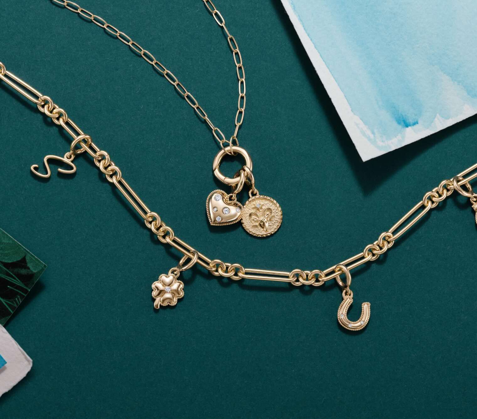 Gold charm bracelet and charm necklace.