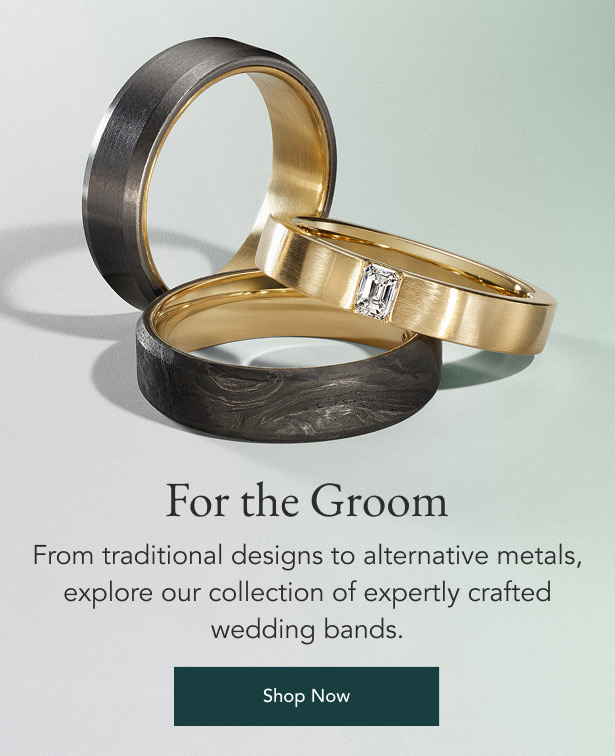 Model wearing a men's gold cuff and silver wedding band.