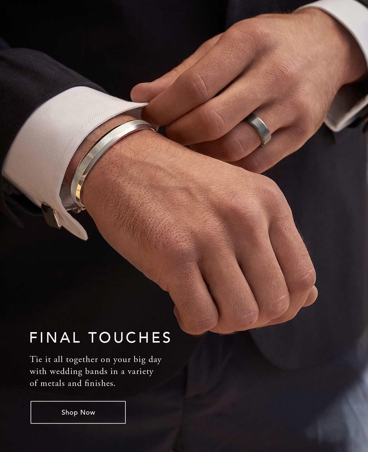 Model wearing a men's gold cuff and silver wedding band.