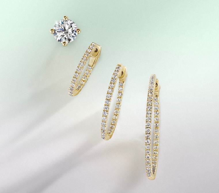 Assortment of gold, diamond hoop earrings.