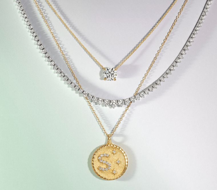 Assortment of gold, diamond necklaces.