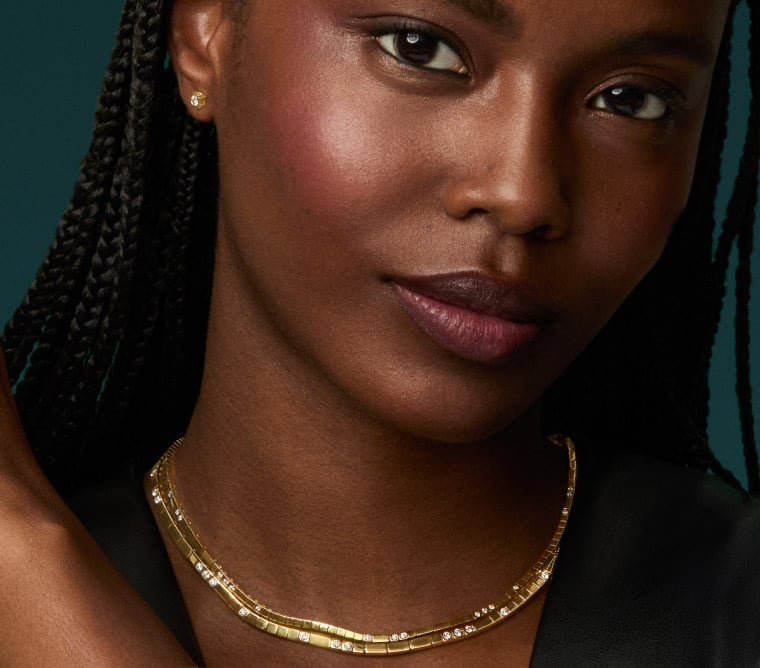 Model wearing gold diamond necklaces from the Love Decoded collection.