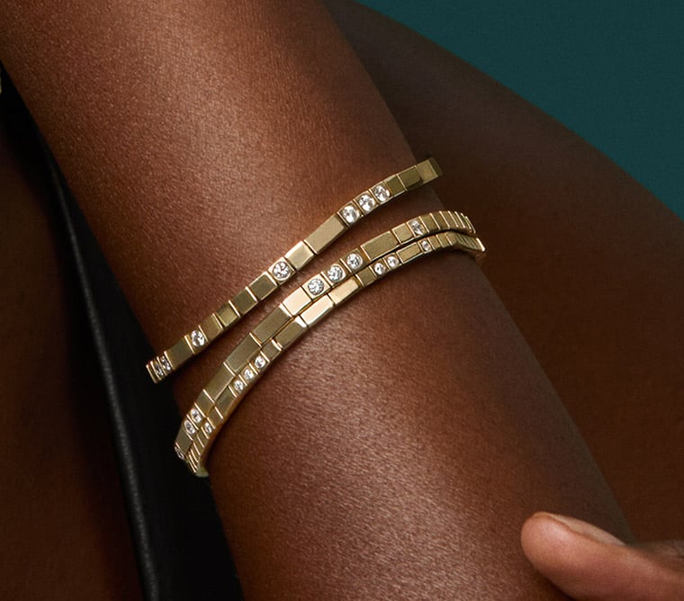 Model wearing gold diamond bracelets from the Love Decoded collection.