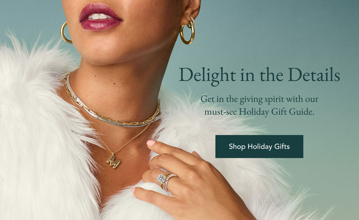 Model wearing fine jewelry pieces perfect for holiday gifts.