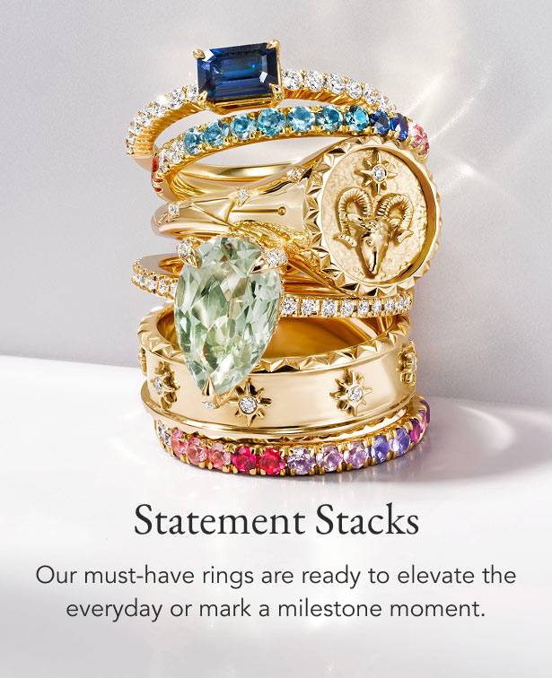 Stack of gold, diamond, and gemstone fashion rings.