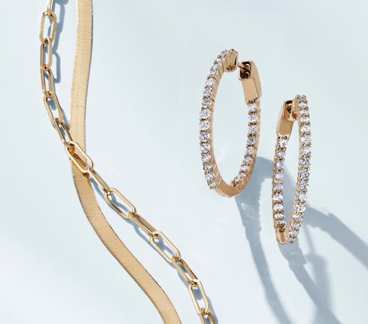 Assortment of gold, chain necklaces and diamond hoop earrings.
