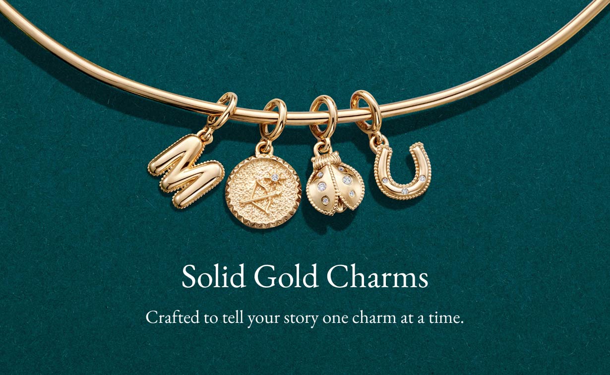 Gold charms on a gold chain necklace.