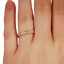 Pia Wedding Ring, smallzoomed in top view on a hand