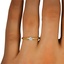 The Edith Engagement Ring, smallzoomed in top view on a hand