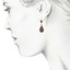 The Corona Earrings, smalltop view on a hand