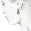 The Sarika Earrings, smalltop view on a hand
