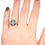 The Caressa Ring, smallzoomed in top view on a hand