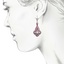 The Versailles Earrings, smalltop view on a hand