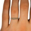 Edith Wedding Ring, smallzoomed in top view on a hand