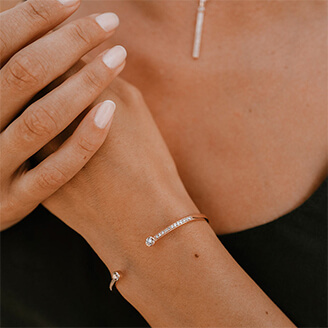 Woman wearing diamond necklace and bracelet