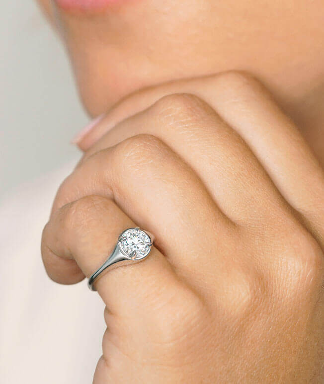 White gold round diamond ring on hand