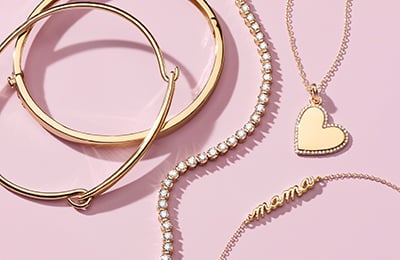 Gold bracelets, diamond tennis necklace, heart shaped necklace, and a personalized mama necklace.