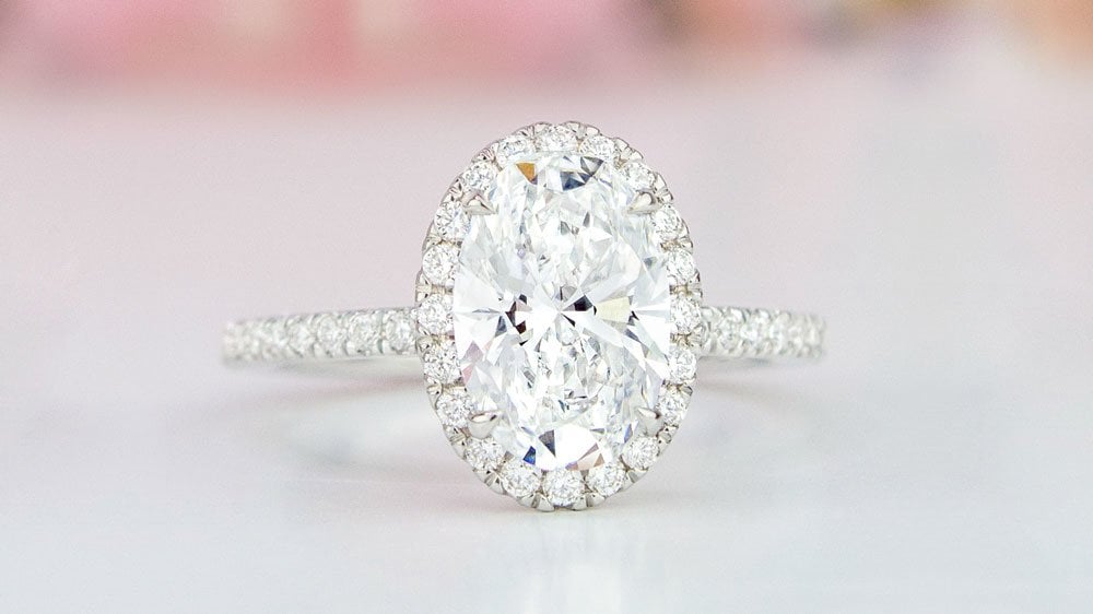 White gold halo oval diamond engagement ring.
